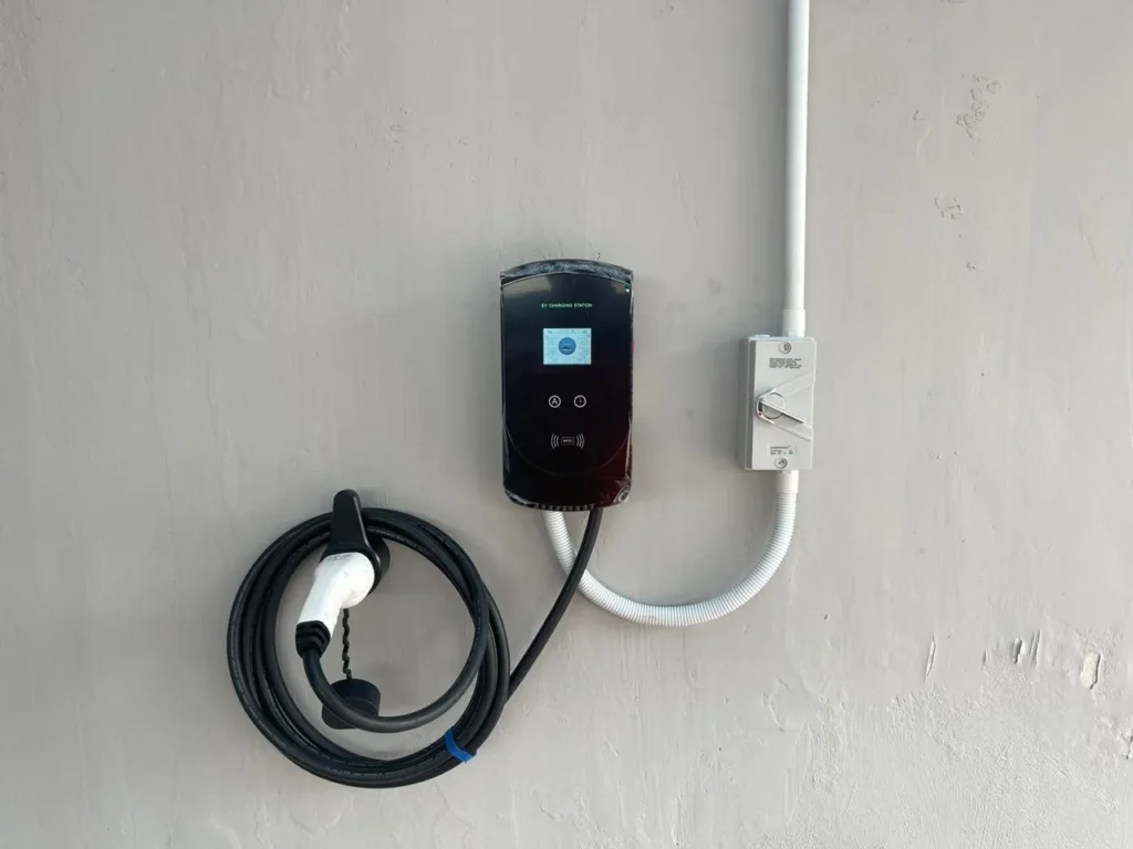 The E1 Charger affixed and mounted to a Wall with an isolator switch .